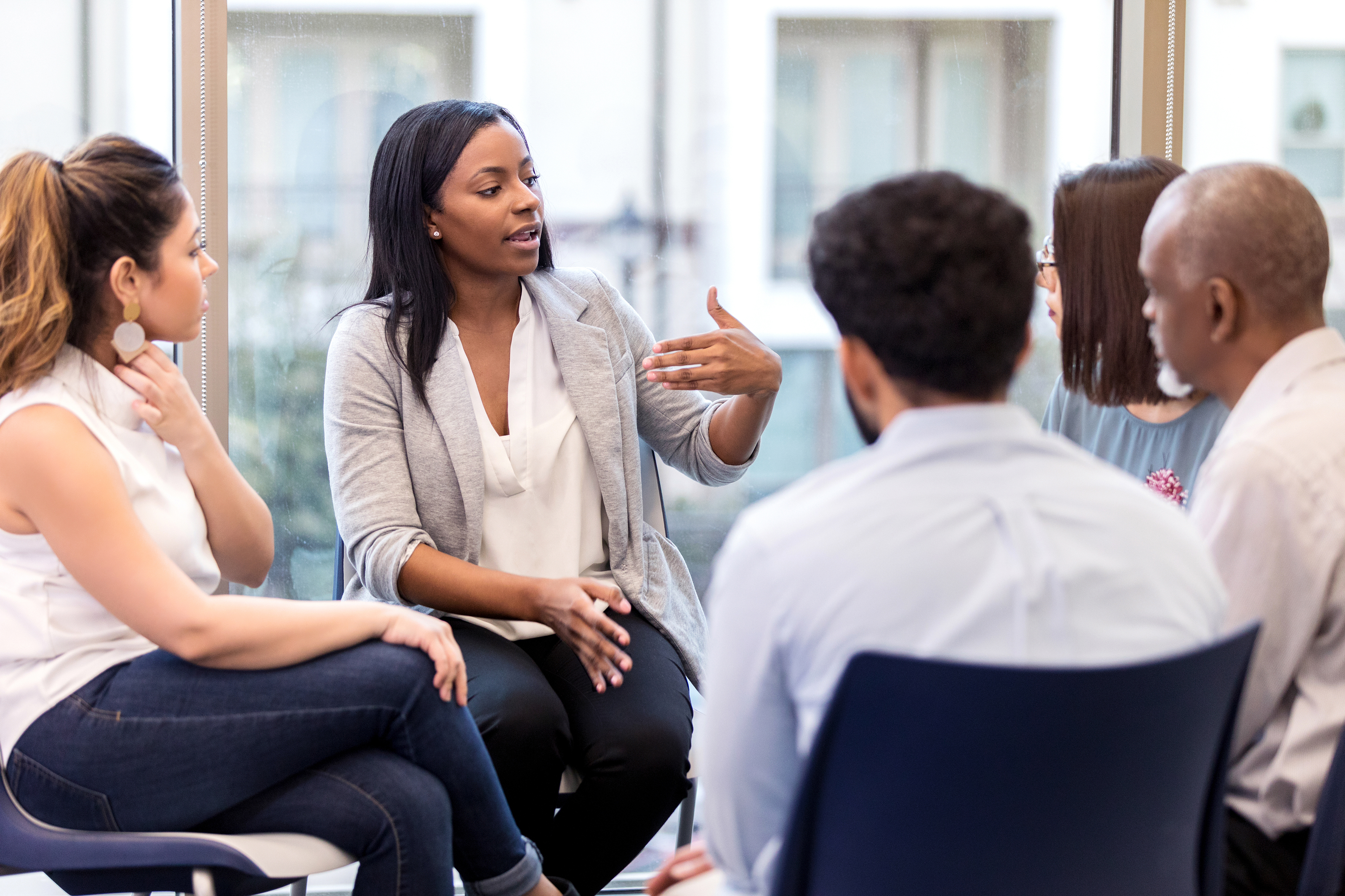 Photograph of group of people sitting together discussing an important issue.